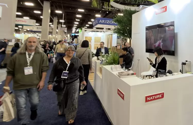 Trade show booth with people on the international surface event 2026.